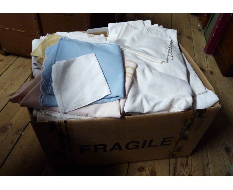 A box containing a quantity of vintage linen and blankets