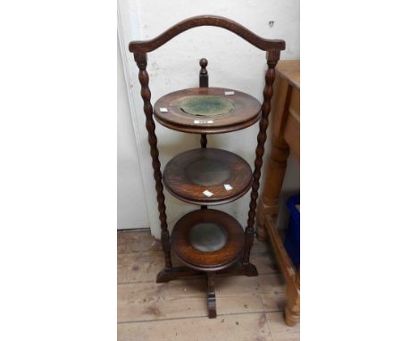 A 1920's stained oak three tier cake stand with bobbin turned supports