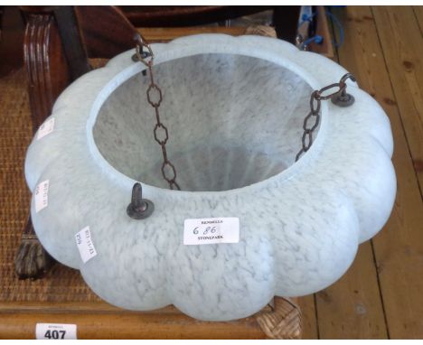 An early 20th Century mottled glass hanging lamp shade of cushion form with original chains and fittings