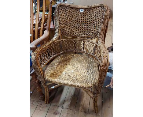 A vintage wicker elbow chair