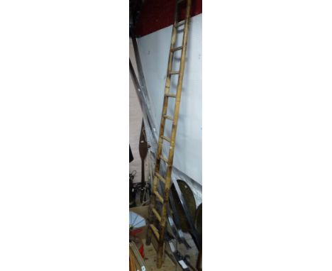A tall old bamboo ladder