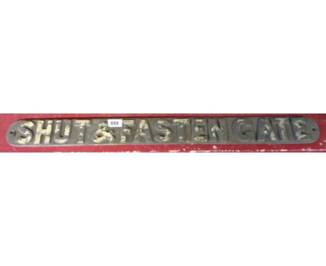 A cast iron railway 'Shut and Fasten the Gate' sign