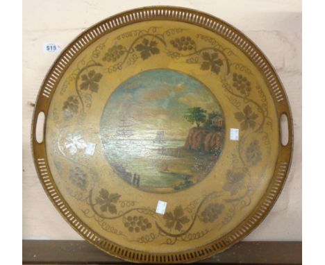 A 19th Century Toleware circular tray with pierced gallery, a central painted panel depicting sailing vessels in a bay and a 