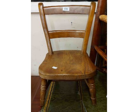 A late Victorian child's chair with solid moulded elm seat, set on ring turned supports - stamped 'S &amp; DR 1888'