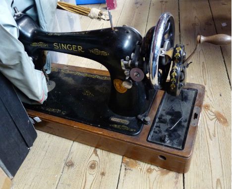A vintage Singer sewing machine, with soft cover
