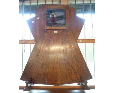 An Art Deco period oak firescreen of cut plank construction with illuminated stained glass panel depicting an owl - in need o