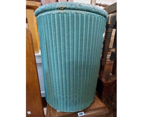 A vintage Lloyd Loom circular line basket with original sprayed turquoise finish and name plaque