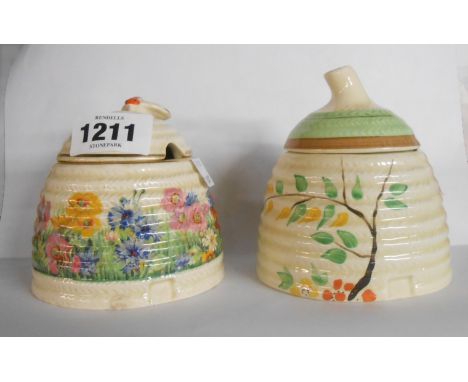 A Clarice Cliff Newport Pottery honey pot with hand painted floral decoration - sold with a similar with transfer printed flo