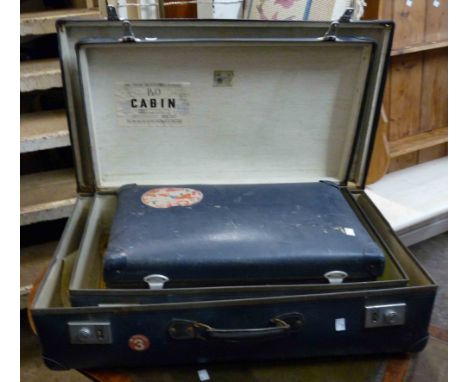 A set of three vintage graduated blue fibreboard suitcases some with shipping line transit stickers