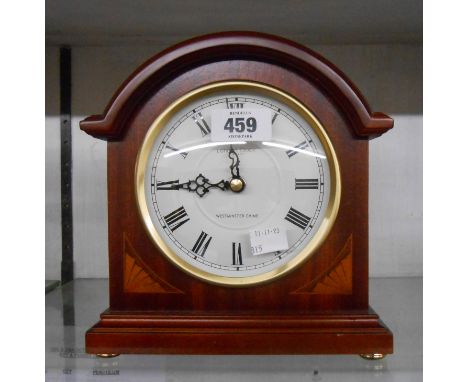 A modern London Clock Company polished wood cased mantel clock with electronic 'Westminster Chime' battery movement - sold wi
