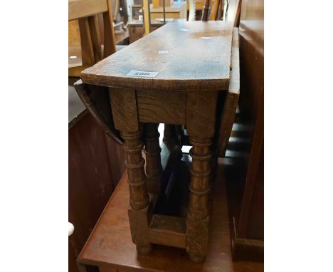 A 60cm early 20th Century oak Sutherland table, set on ring turned supports - wear