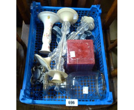 A small crate containing a quantity of candlesticks including ceramic, glass, etc.