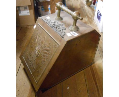 An old brass coal box with embossed panel lift-front