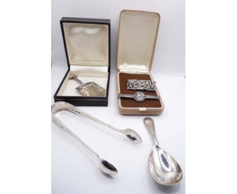 A boxed silver sugar shovel - sold with a pair of silver sugar tongs, two silver Celtic design brooches and a plated caddy sp