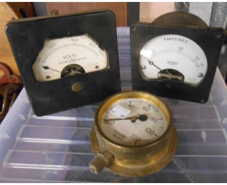A box containing a vintage voltmeter and a pressure gauge