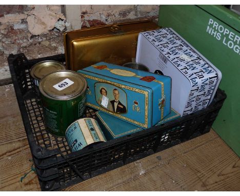 A crate containing a quantity of vintage and other tins