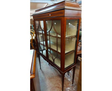 A 1.1m Edwardian mahogany and strung display cabinet with material lined interior and shelves enclosed by a pair of beaded gl