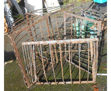 Four vintage iron hay racks