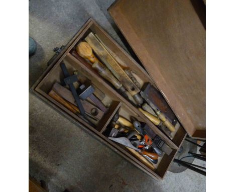 A wooden box with lift-out tray containing a quantity of tools including planes, chisels, etc.