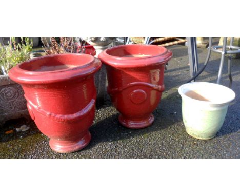 A pair of large red glazed ceramic plant pots - sold with a small ceramic plant pot