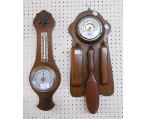 A vintage hall barometer and clothes brush set with visible aneroid works to dial centre and three brushes under, set on an o