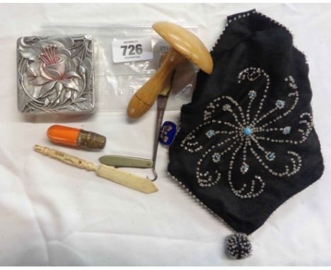 A vintage beadwork bag containing a quantity of collectable items including silver and enamel brooch, button hooks, etc.