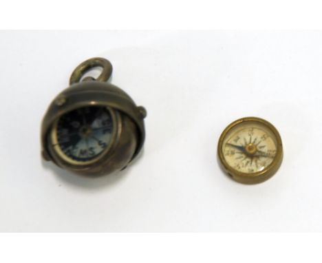 TWO MINIATURE COMPASSES, one in a metal gimbaled case with ring hanger 
