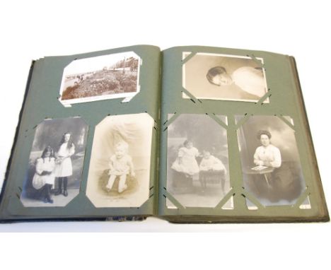 AN EARLY 20TH CENTURY ALBUM OF POSTCARDS including embroidered silk cards, Edwardian 'Heroes of the Mine' cards, 'Titanic' co