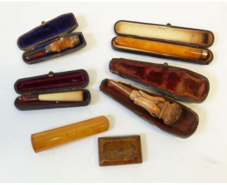 A LATE NINETEENTH CENTURY CRAVED MEERSCHAUM AND AMBER CHEROOT HOLDER in case, an EARLY 1900's AMBER CHEROOT HOLDER with 9ct r