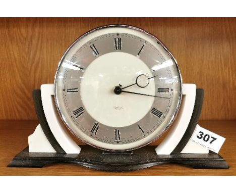 An Art Deco Bakelite mantle clock, W. 26cm. Understood to be in working order.