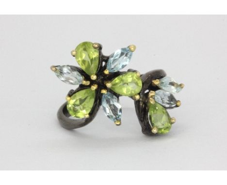 A 925 silver ring set with marquise cut blue topaz and pear cut peridots, (O.5).
