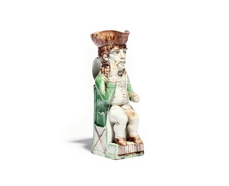 A Wood family Thin Man Toby jug c.1780, crisply modelled and seated on a stepped base, holding the stem of his clay pipe in h