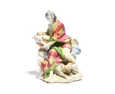 A large Chelsea figure emblematic of Smell  c.1756-60, modelled by Joseph Willems as a young boy seated on a rocky stump with