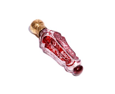 A glass scent bottle  19th century, the shaped form flashed with ruby and decorated with a figure of Harlequin and a bird amo