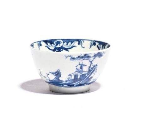 A rare Worcester blue and white teabowl  c.1758, painted with the Diagonal Rock Island pattern, a Chinese figure standing wit