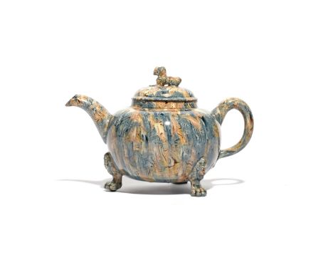 A Staffordshire agateware teapot and cover  c.1755, the squat globular body with blue and manganese striations, raised on thr