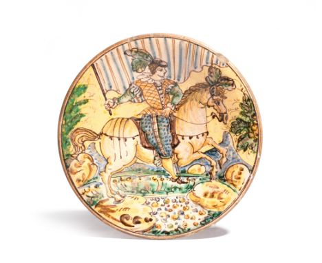 A Montelupo charger  late 17th century, painted with an equestrian portrait of a figure riding a horse with plumed decoration