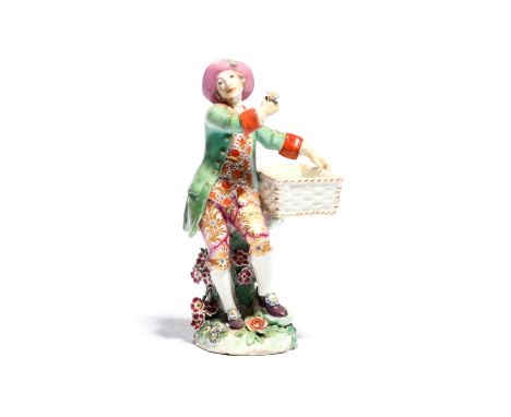 A Chelsea sweetmeat figure c.1760, modelled as a gallant holding a rectangular basket and with a single flower in his right h