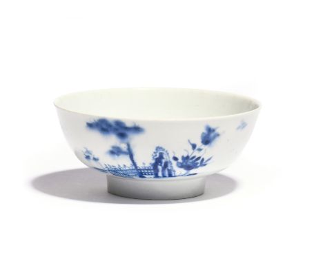 A Worcester blue and white slop bowl c.1754-56, painted with the Plantation pattern, with bamboo and flowering branches by a 