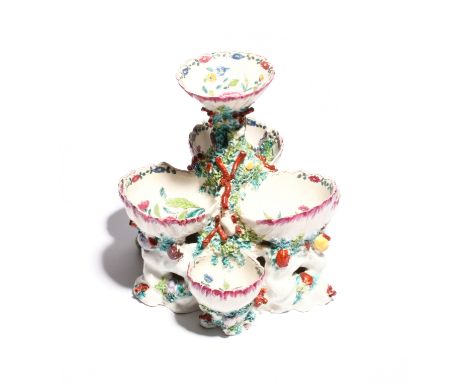 A large Bow three-tier sweetmeat stand  c.1765, modelled with deep scallop shells painted to the interior with flowers in the