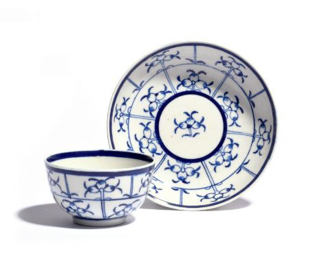 A rare Worcester blue and white teabowl and saucer  c.1785, of generous size, decorated in the Trellis Lily pattern with a fo