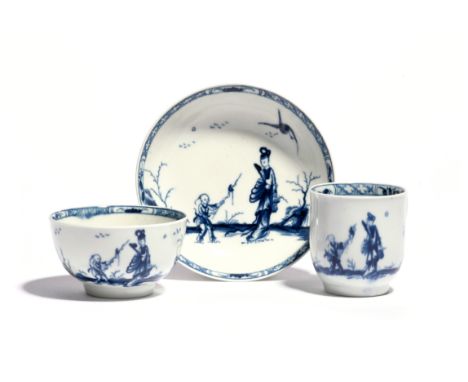 A Worcester blue and white associated trio  c.1760, comprising a coffee cup, teabowl and saucer, painted with the Walk in the
