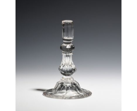 A glass taper stick  c.1750, with inverted pedestal stem above a panel moulded foot, 12.8cm. Provenance: the collection of th