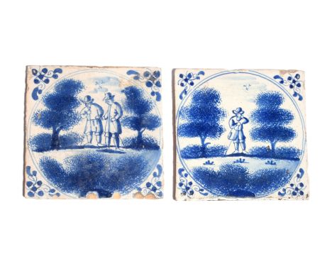 Two delftware tiles  c.1700, probably London, painted in blue with figures standing between sponged trees within a double rin