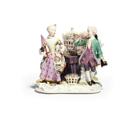 A Meissen figure group of children mid 18th century, a boy seated and playing the flageolet to a bird in a cage resting on a 