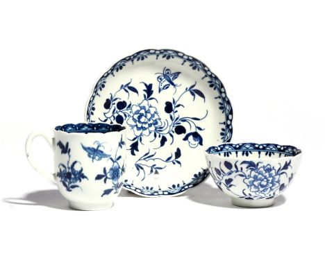 A Worcester blue and white trio  c.1770, comprising a coffee cup, teabowl and saucer, the scallop-edged forms painted with th