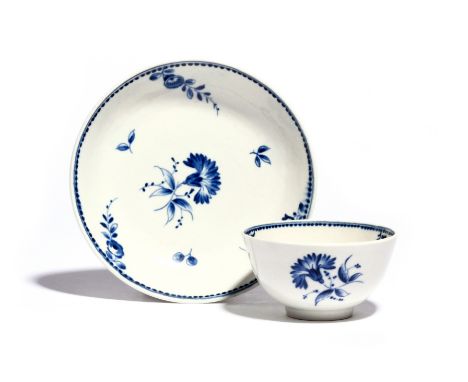 A rare Worcester blue and white teabowl and saucer  c.1785, painted with the Caughley Gilliflower pattern, the central sprig 