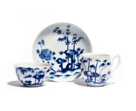 A rare Worcester blue and white trio  c.1756, comprising a teabowl, coffee cup and saucer, the coffee cup with wishbone handl