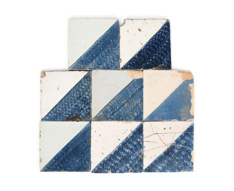 Eight delftware tiles  c.1740-50, Wincanton or possibly Friesland, half of each tile covered diagonally in a sponged blue gla