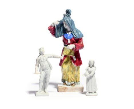 An unusual Buen Retiro figure of a Turkish or Levantine lady  late 18th century, raising a blue veil away from her face, wear